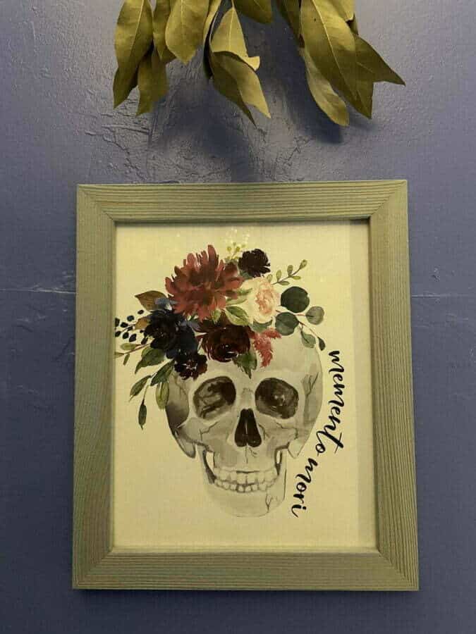 framed art print of skull with flowers and "memento mori"
